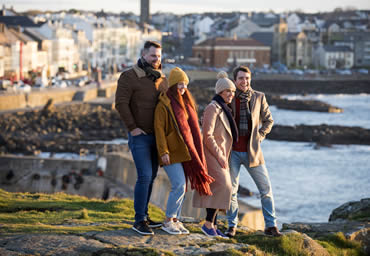 Friends watching sunset in Portstewart